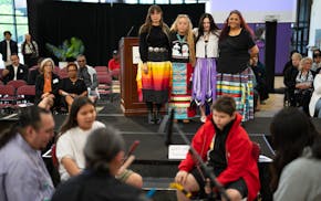 From left, Shaneesa Scheckel, Nicole Poitra, Montana Moore and Lolita Spotted Thunder Granados listen to the White Elk Singers perform the Lakota hono
