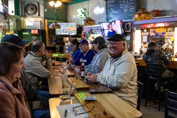 Craig Sandberg laughs while playing cribbage at Otter's Saloon in Minneapolis on Nov. 30.