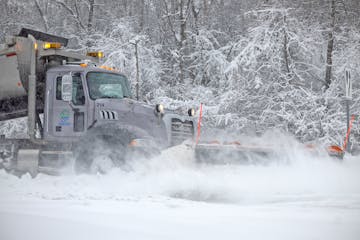 City of Burnsville snowplows make their way down Southcross Drive on Wednesday.